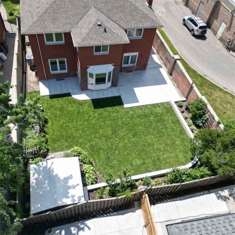 Backyard patio and walkway around a lawn, from above