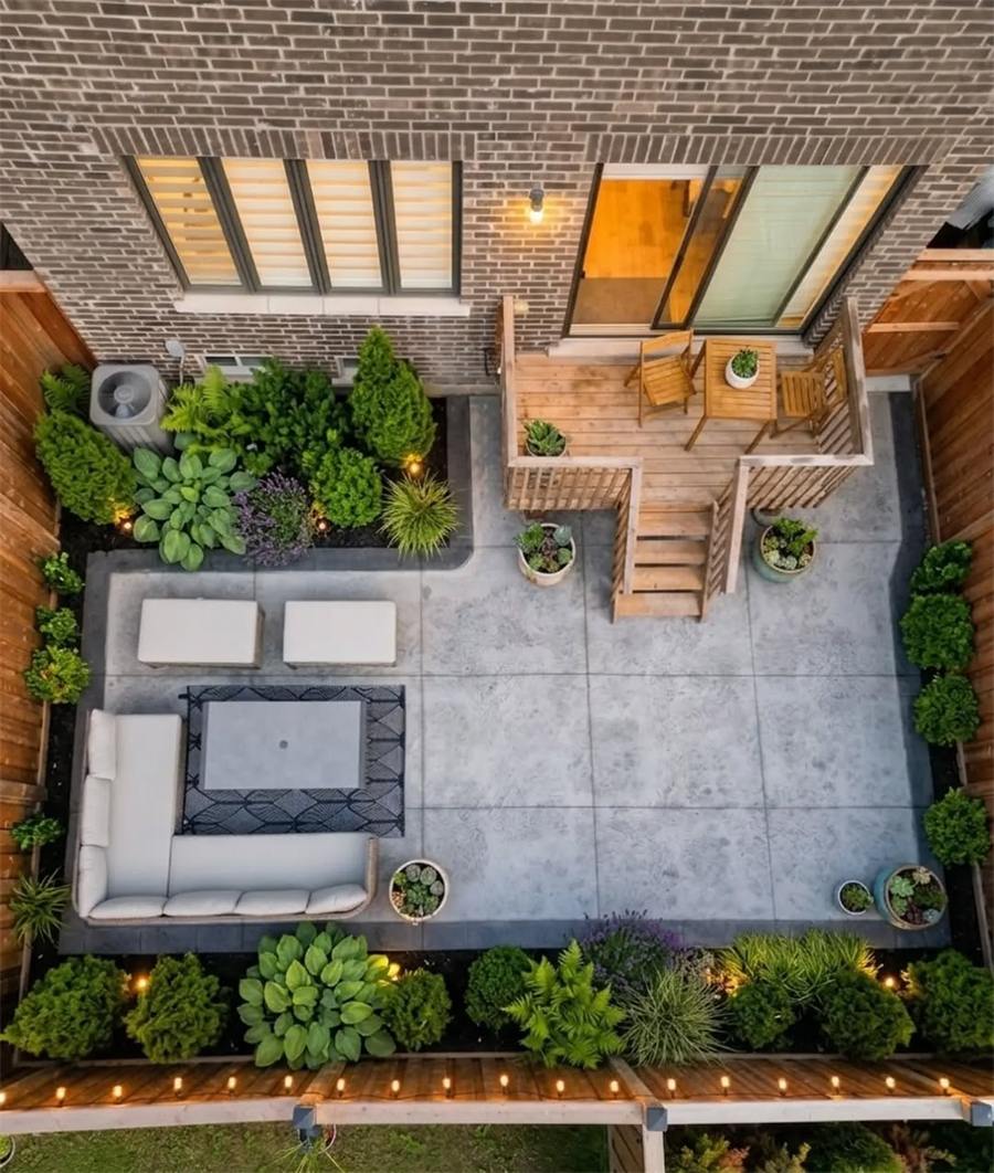 Concrete backyard patio with furniture and planting, from above