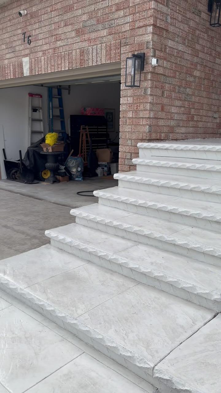 New white concrete steps beside a garage